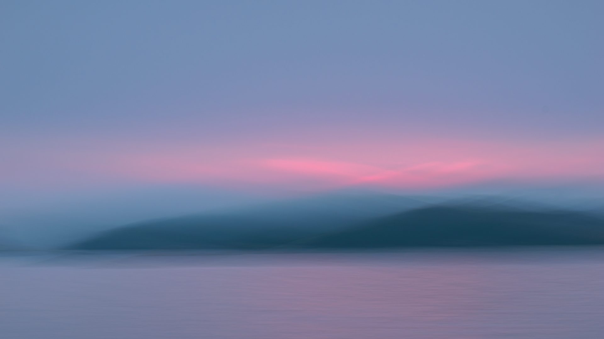 Soft pastel dawn over a misty freshwater coast